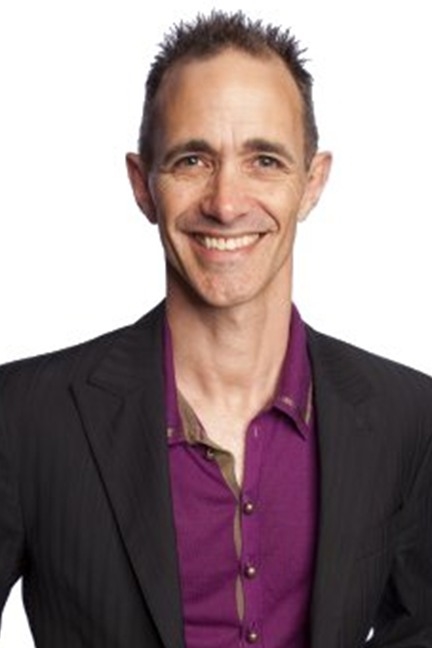 a male person with short hair in a purple shirt and black jacket
