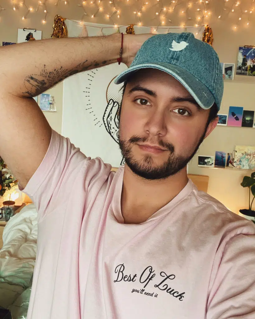 a person in a baseball cap and pink tee
